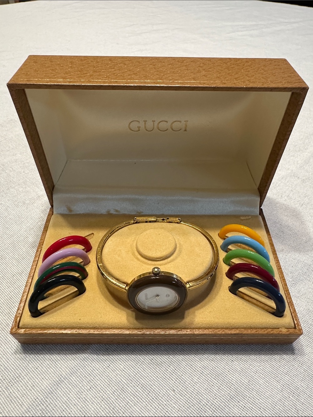 Gucci Vintage Gold Tone Bangle Watch, White Dial, with Multicolor Bezels